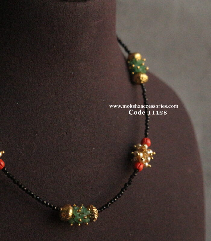 Black beads with emerald, corals, sarvoski pearls and real nakshi balls